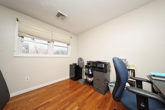 home office featuring baseboards, visible vents, and wood finished floors