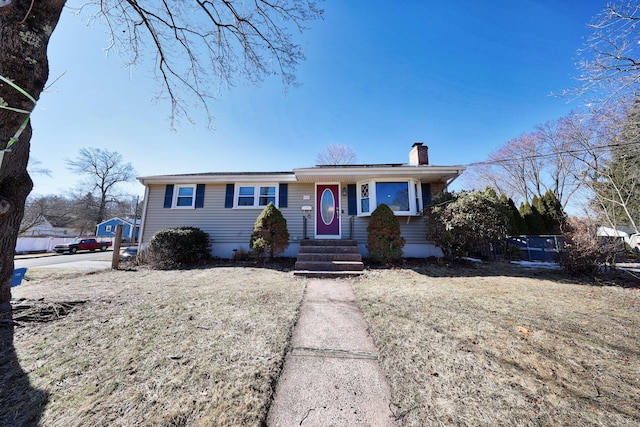 single story home with entry steps and a chimney