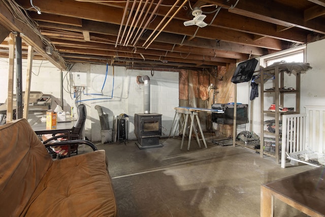 unfinished basement featuring a wood stove