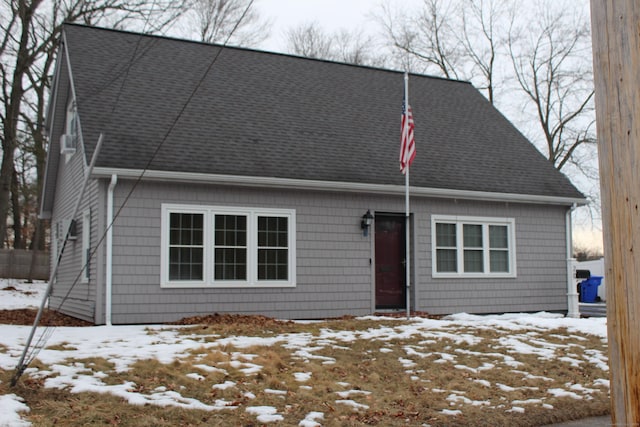 cape cod-style house with a shingled roof