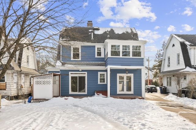 snow covered house with a chimney