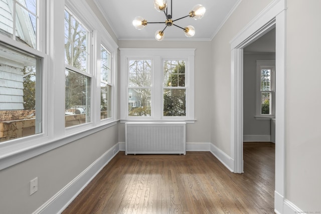 unfurnished sunroom with radiator and a notable chandelier