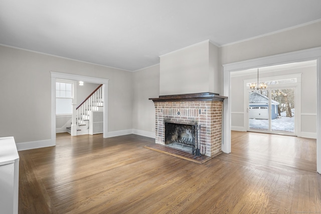 unfurnished living room with a fireplace, baseboards, and wood finished floors