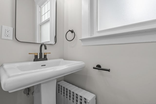 bathroom featuring a sink and radiator heating unit