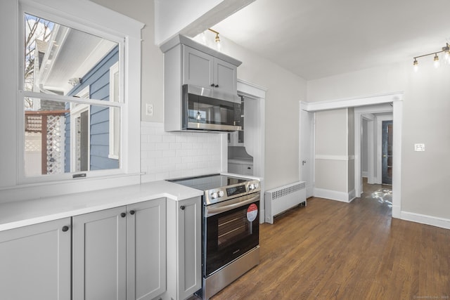 kitchen featuring stainless steel appliances, radiator, light countertops, and gray cabinets