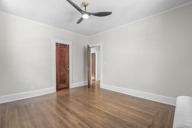 unfurnished room featuring a ceiling fan, crown molding, baseboards, and dark wood-style floors