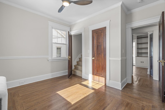 unfurnished bedroom featuring dark wood-style floors, crown molding, and baseboards