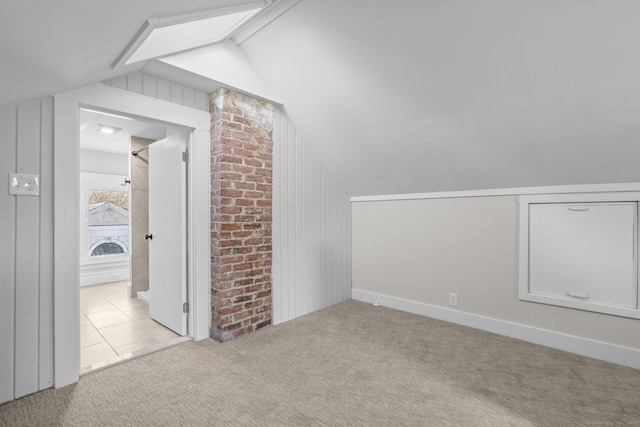 additional living space featuring lofted ceiling and light colored carpet