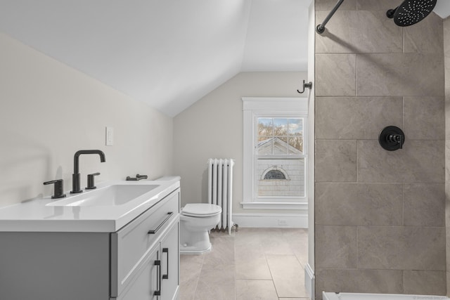 bathroom with radiator, lofted ceiling, a tile shower, and vanity