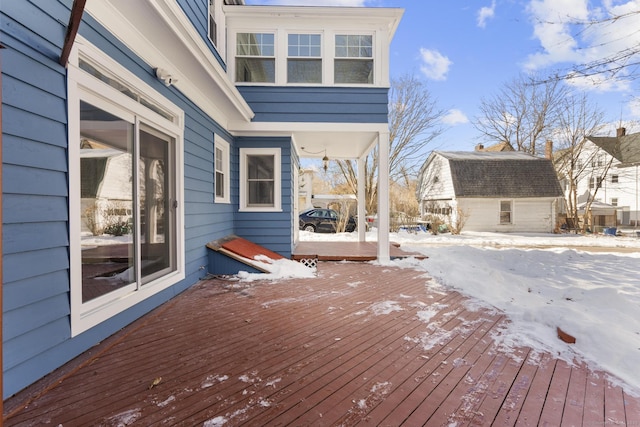 snow covered deck with an outdoor structure