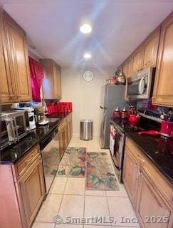 kitchen featuring appliances with stainless steel finishes, recessed lighting, a sink, and light tile patterned floors