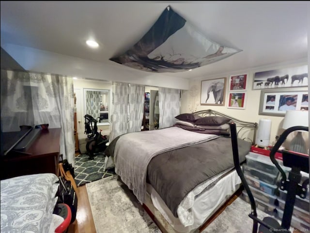 bedroom with wood finished floors and recessed lighting