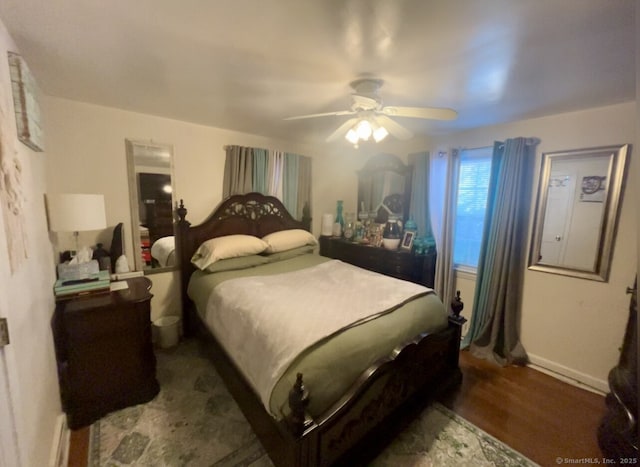 bedroom featuring ceiling fan and dark wood finished floors