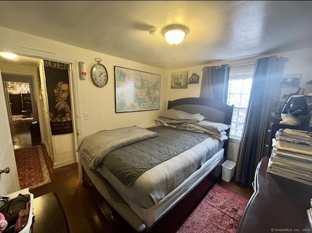 bedroom with dark wood-type flooring