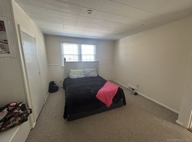 carpeted bedroom featuring visible vents and baseboards