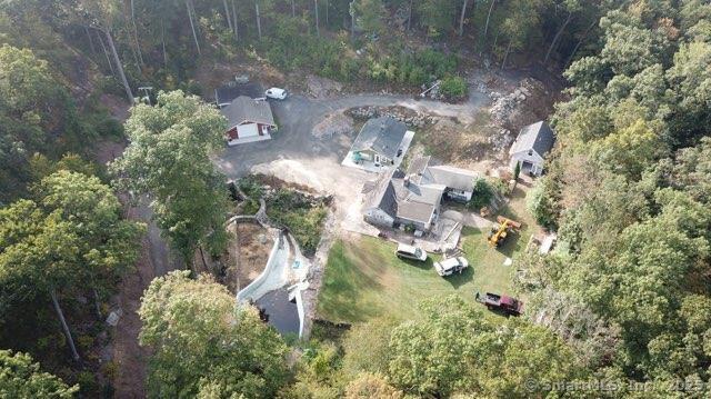 birds eye view of property with a view of trees