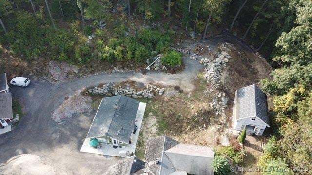 birds eye view of property with a wooded view