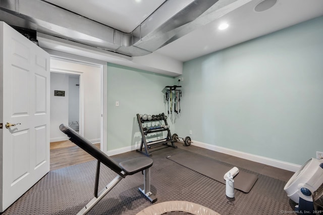 exercise area featuring recessed lighting and baseboards