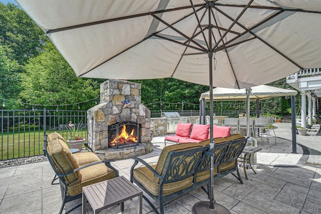 view of patio / terrace with outdoor dining area, an outdoor living space with a fireplace, fence, and grilling area