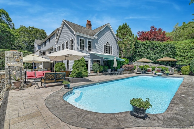 pool featuring a patio area and outdoor lounge area