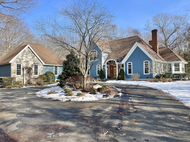 view of front of house featuring driveway and a chimney