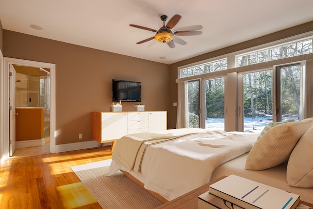 bedroom with access to exterior, light wood finished floors, and baseboards