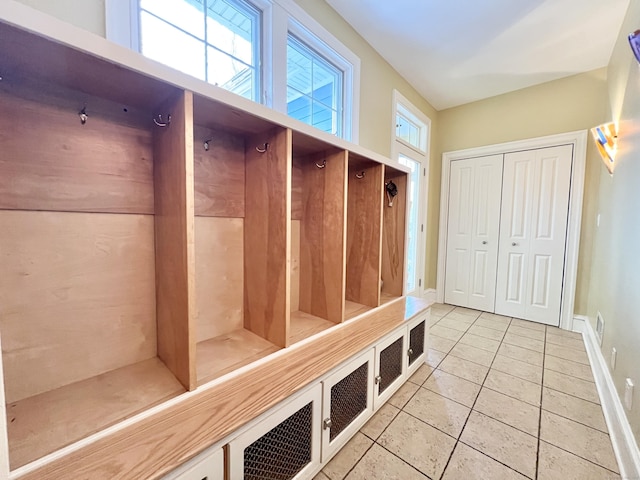 mudroom featuring baseboards and light tile patterned flooring