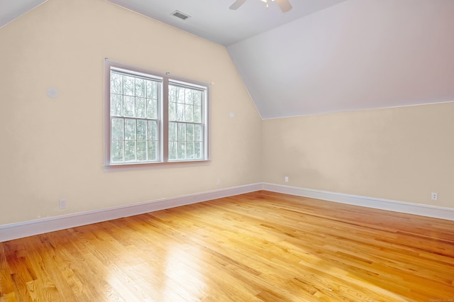 bonus room with visible vents, a ceiling fan, vaulted ceiling, wood finished floors, and baseboards