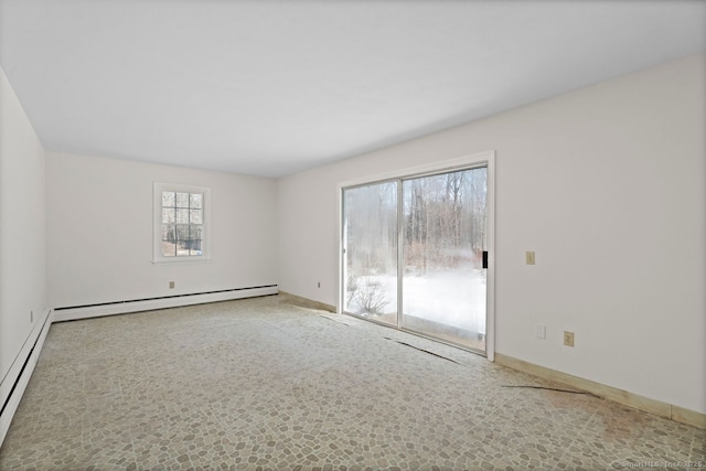 empty room featuring a baseboard heating unit, a baseboard radiator, and baseboards