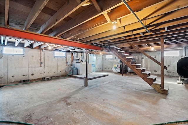 basement with washer / clothes dryer, stairway, and heating fuel