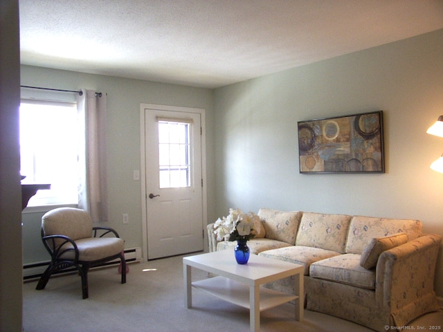 living area featuring baseboard heating and light colored carpet