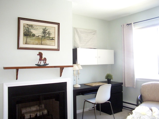 office area featuring a fireplace and a baseboard radiator