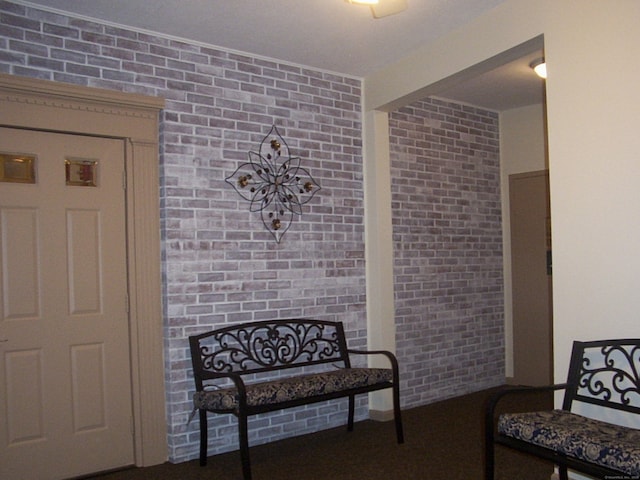 sitting room with brick wall