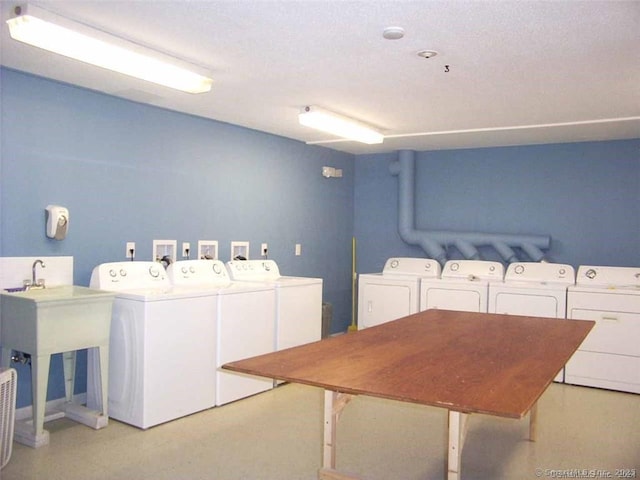 community laundry room featuring washer and clothes dryer