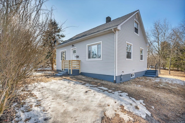 bungalow featuring a chimney