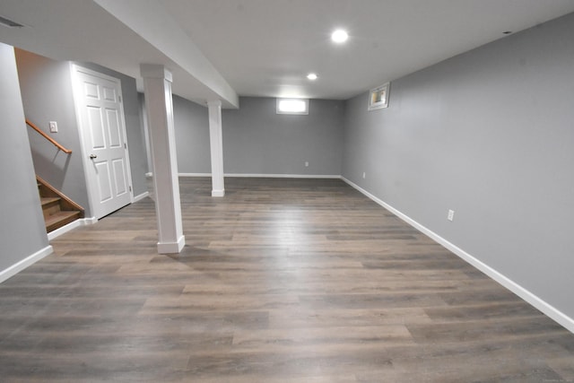 basement with dark wood-type flooring, recessed lighting, baseboards, and stairs