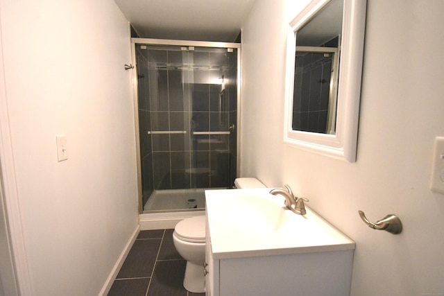 bathroom featuring toilet, vanity, baseboards, tile patterned floors, and a stall shower