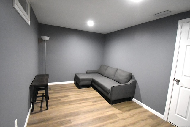 living area featuring baseboards and wood finished floors