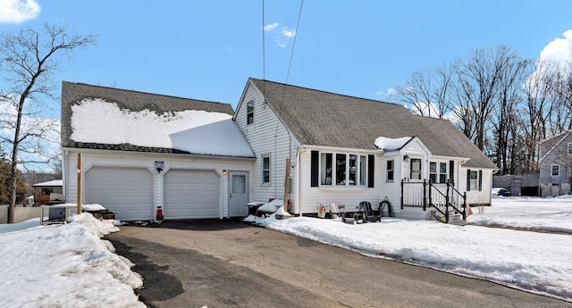 view of front of home featuring aphalt driveway, a shingled roof, and an attached garage