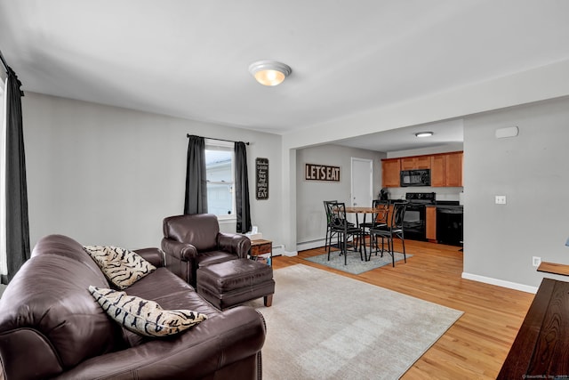 living room with light wood-style flooring and baseboards