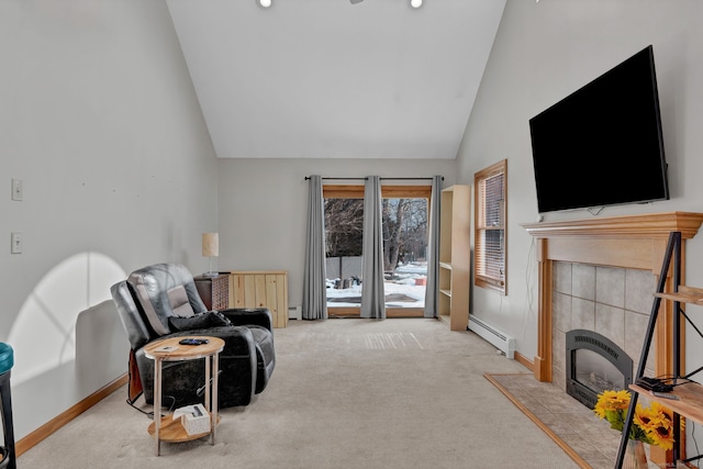 sitting room featuring carpet, a baseboard heating unit, high vaulted ceiling, a tile fireplace, and baseboards