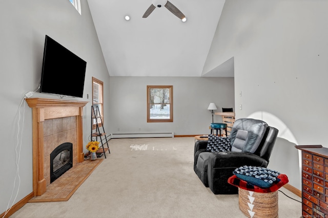 living area with baseboards, carpet, baseboard heating, a fireplace, and high vaulted ceiling