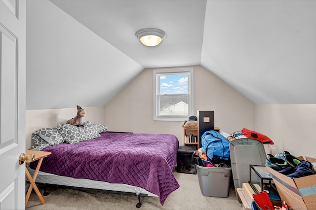 carpeted bedroom featuring lofted ceiling