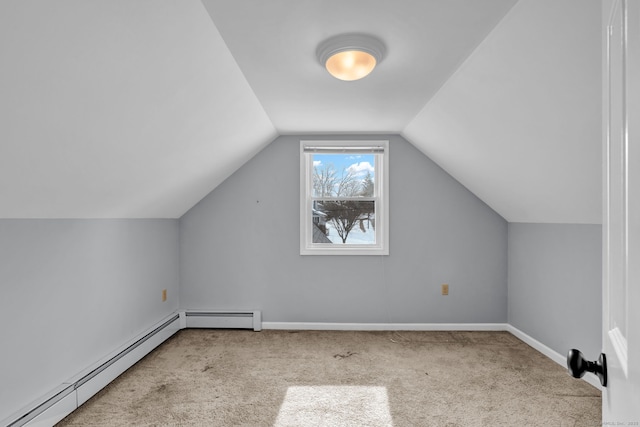 additional living space featuring a baseboard heating unit, carpet, lofted ceiling, and baseboards