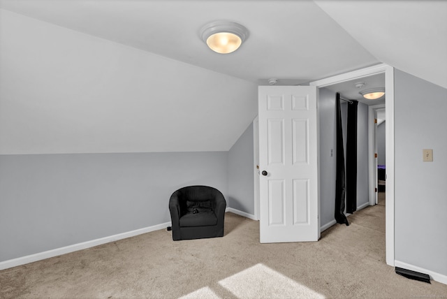 unfurnished room with lofted ceiling, carpet flooring, and baseboards