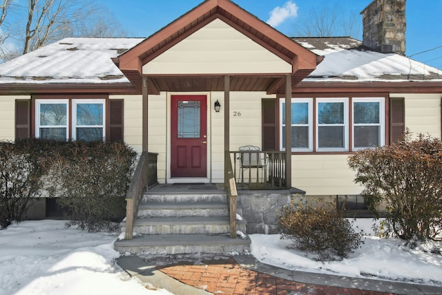 view of front of property with a porch and a chimney