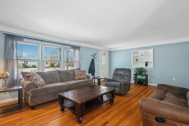 living room featuring ornamental molding, light wood-style floors, and a healthy amount of sunlight