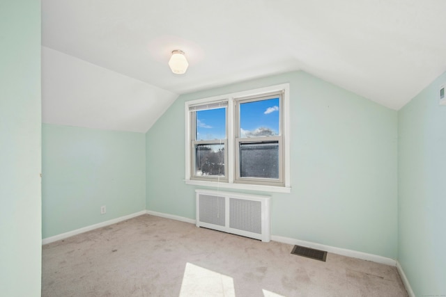 bonus room featuring carpet floors, radiator, visible vents, and baseboards