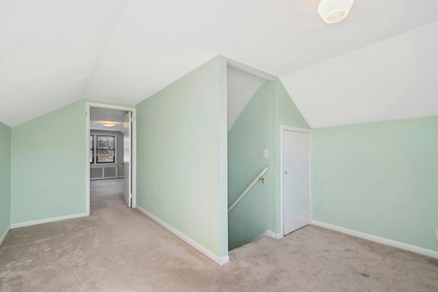 bonus room featuring carpet, baseboards, and vaulted ceiling