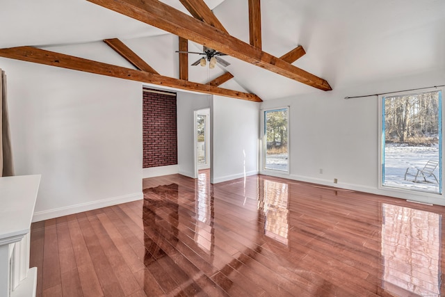 unfurnished living room with baseboards, wood-type flooring, ceiling fan, high vaulted ceiling, and beam ceiling